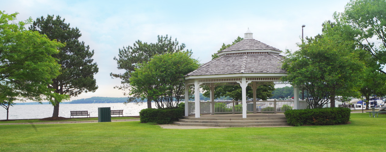 A picture of a gazebo in front of a lake
